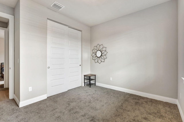 unfurnished bedroom featuring carpet floors and a closet