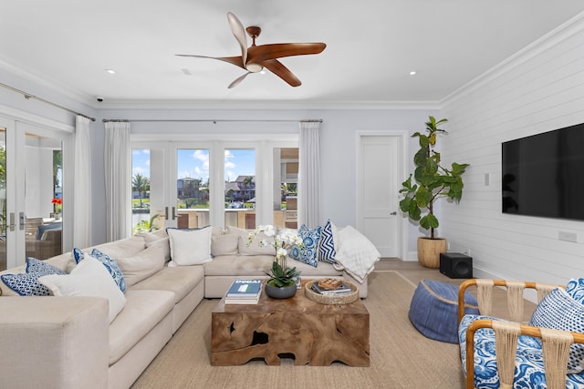 living room featuring ceiling fan, ornamental molding, and french doors