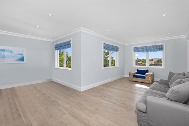 living room with ornamental molding and light wood-type flooring