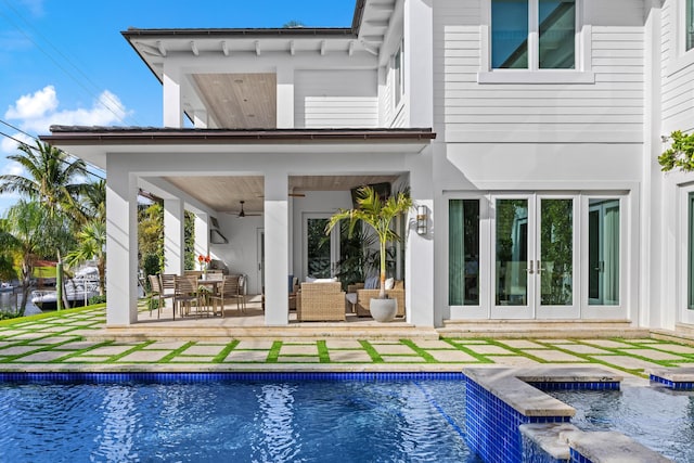 rear view of house featuring ceiling fan, an outdoor hangout area, a patio, and french doors