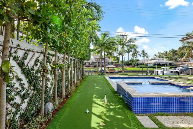 view of pool with a hot tub