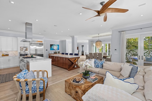 living room with french doors, light hardwood / wood-style floors, ceiling fan, and crown molding