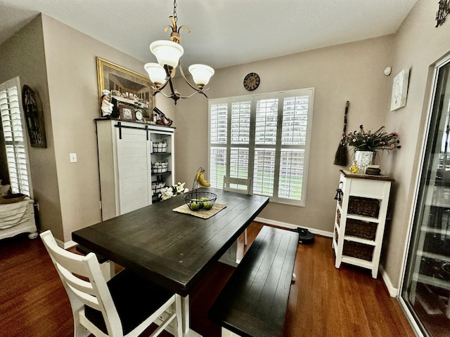 dining space featuring a healthy amount of sunlight, dark wood-type flooring, and a chandelier