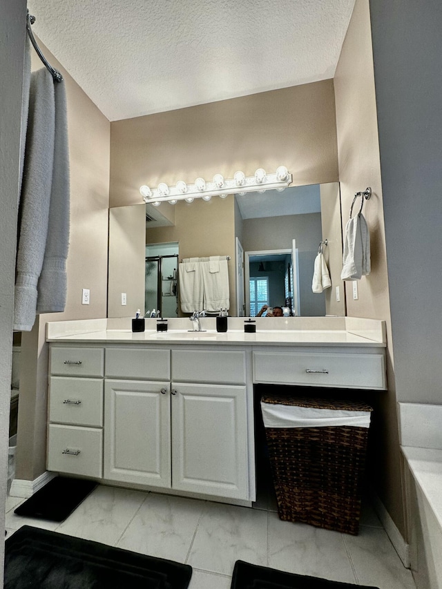 bathroom with vanity and a textured ceiling