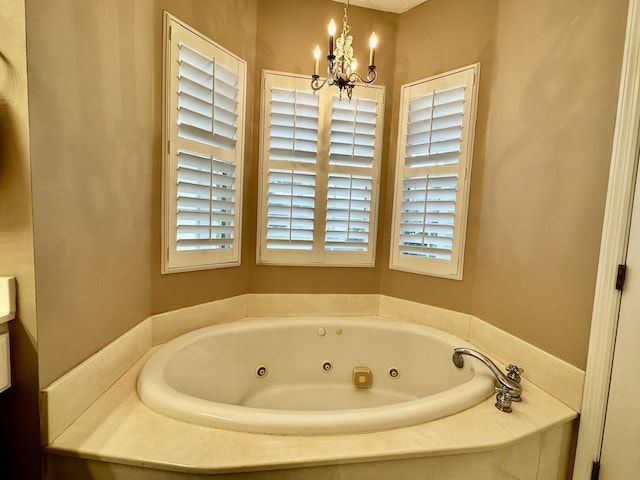 bathroom featuring a bathing tub and a notable chandelier