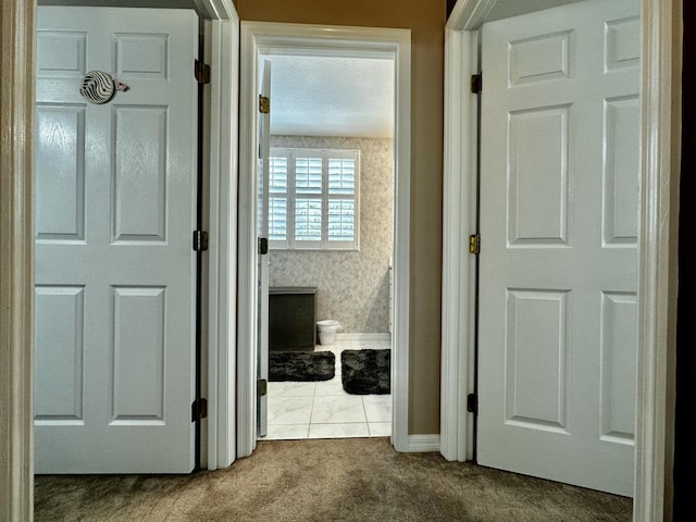 hallway with carpet floors