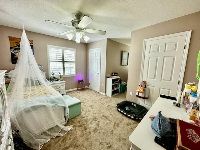 bedroom with a textured ceiling, light colored carpet, and ceiling fan