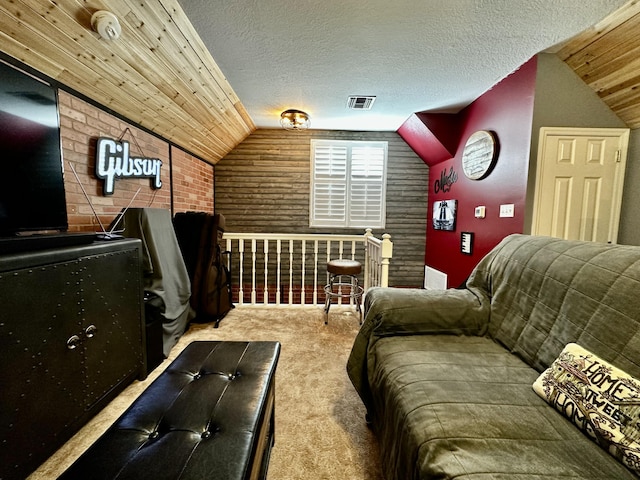 carpeted cinema room with lofted ceiling, wooden ceiling, a textured ceiling, and brick wall