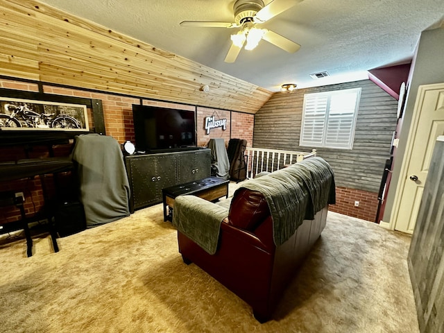 carpeted home theater room featuring ceiling fan, brick wall, a textured ceiling, lofted ceiling, and wooden walls