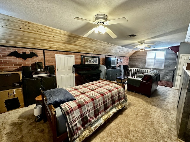 carpeted bedroom featuring ceiling fan, brick wall, and a textured ceiling