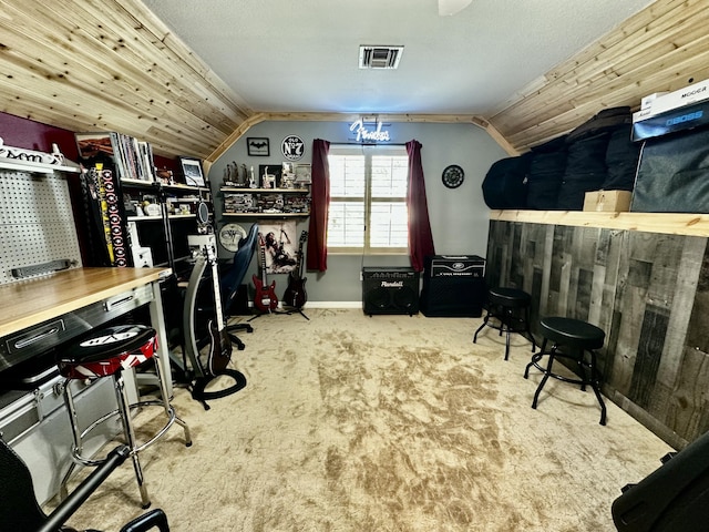 office space with carpet flooring, wooden walls, and lofted ceiling