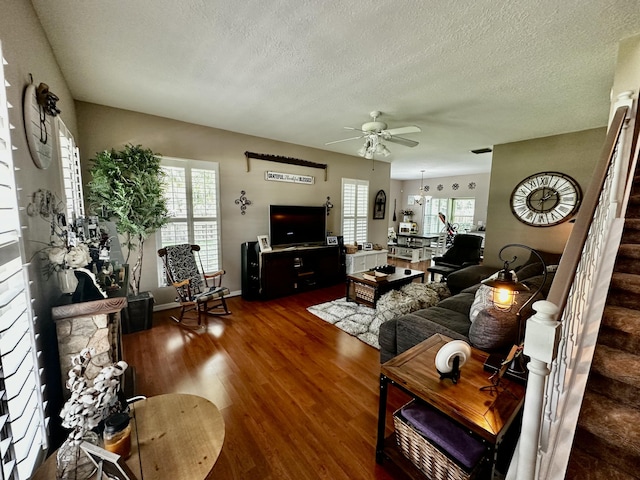 living room featuring ceiling fan, a textured ceiling, and hardwood / wood-style flooring