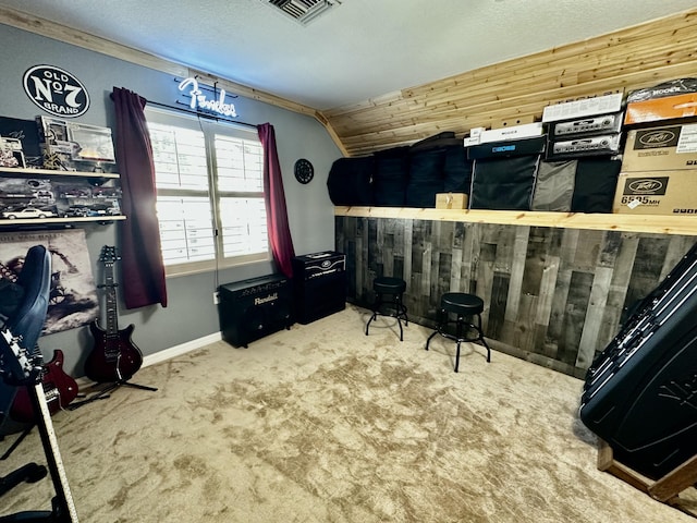 bedroom with wood walls, carpet floors, and lofted ceiling