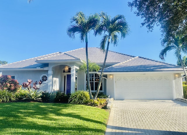 ranch-style home with a front yard and a garage