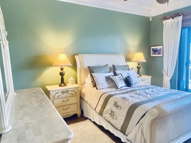 bedroom featuring ceiling fan and ornamental molding