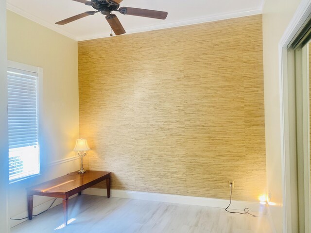 interior space featuring ceiling fan, light hardwood / wood-style floors, and ornamental molding