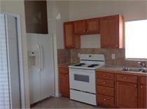 kitchen with decorative backsplash, white appliances, and sink