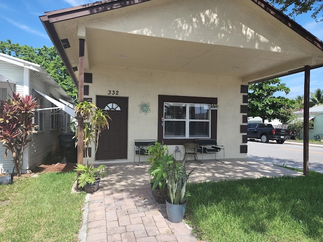 doorway to property featuring covered porch