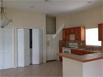 kitchen with kitchen peninsula, stove, and light tile patterned flooring