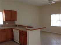 kitchen featuring white dishwasher, decorative backsplash, ceiling fan, light tile patterned flooring, and kitchen peninsula