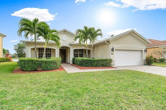 view of front of property with a front yard and a garage