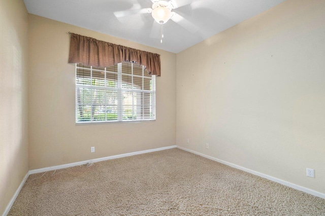 unfurnished room featuring ceiling fan and carpet floors