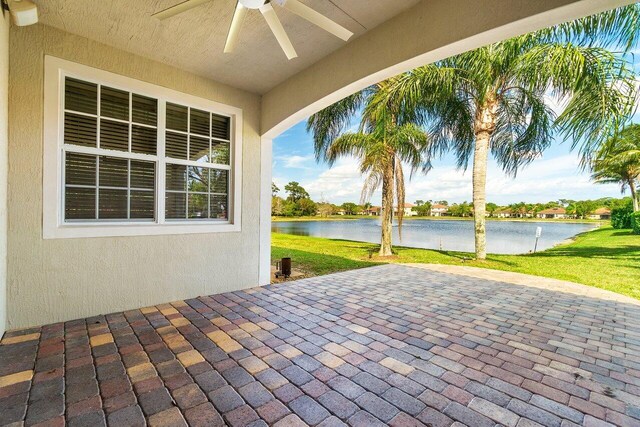 back of property with a yard and a patio