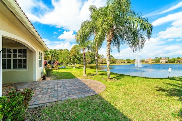 view of yard with a patio area and a water view