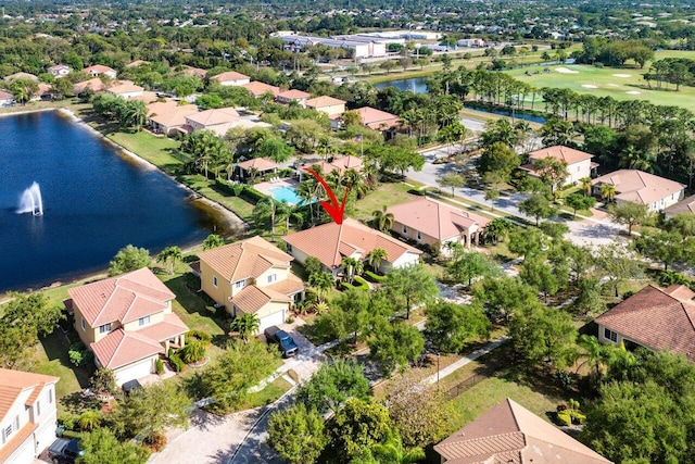 drone / aerial view with a water view and a residential view