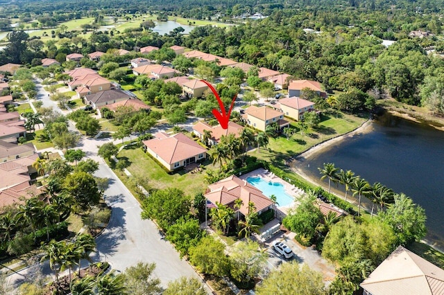 birds eye view of property with a water view and a residential view