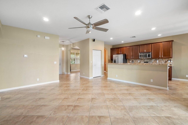 kitchen featuring ceiling fan, light stone counters, decorative backsplash, light tile patterned floors, and appliances with stainless steel finishes