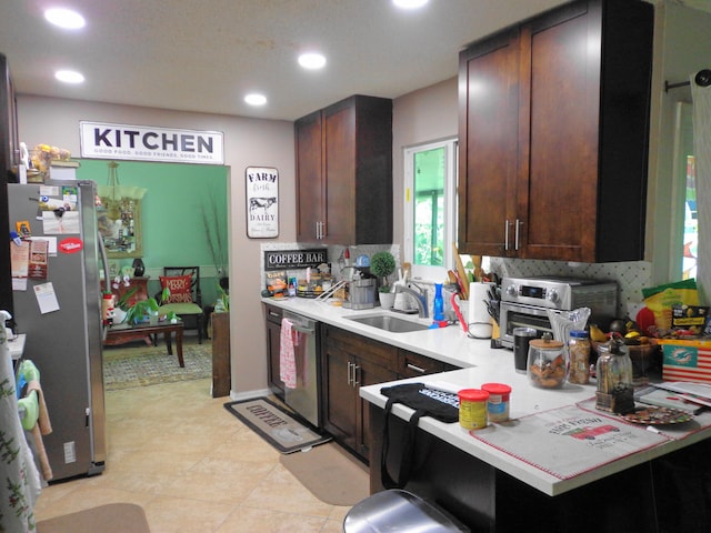 kitchen with sink, dark brown cabinetry, and stainless steel appliances