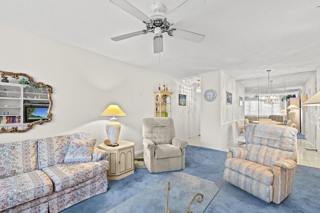 carpeted living room featuring ceiling fan with notable chandelier and a textured ceiling