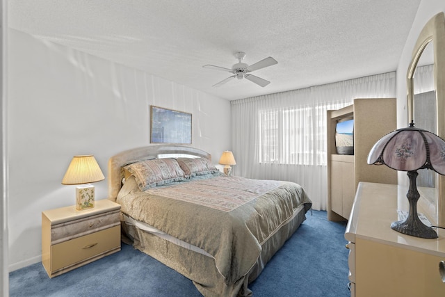 bedroom featuring ceiling fan, a textured ceiling, and dark colored carpet