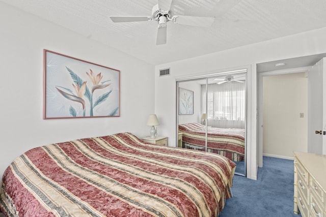 carpeted bedroom featuring ceiling fan, a closet, and a textured ceiling