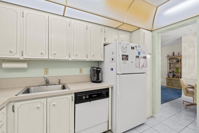 kitchen featuring light tile patterned flooring, white appliances, white cabinets, and sink