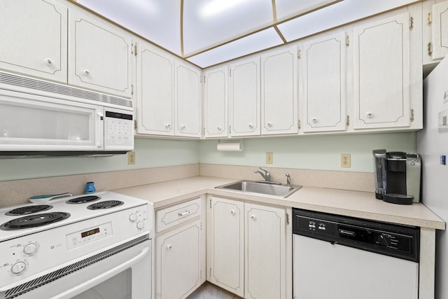 kitchen with white cabinets, white appliances, and sink