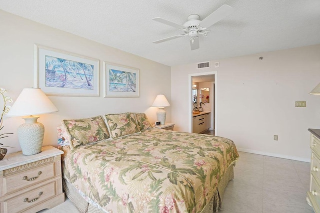 bedroom with ceiling fan, a textured ceiling, and connected bathroom