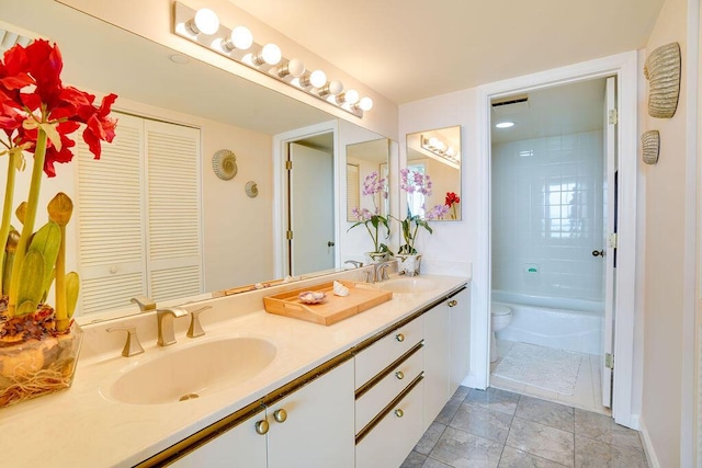 full bathroom featuring vanity, toilet, and tiled shower / bath