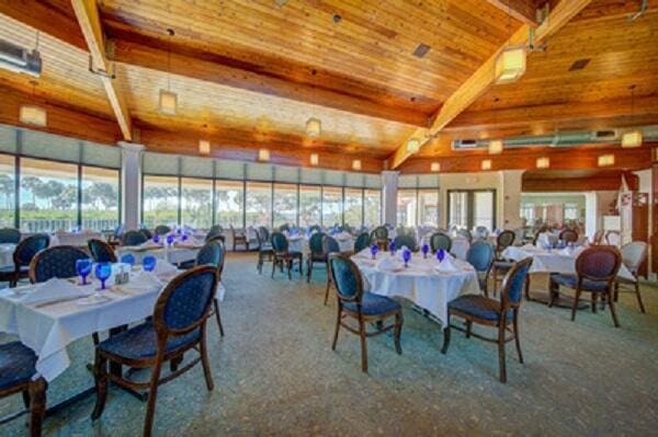 dining area featuring carpet flooring, plenty of natural light, beamed ceiling, and wood ceiling