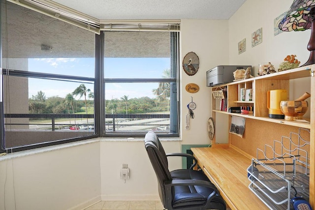 office space featuring light tile patterned flooring and a textured ceiling