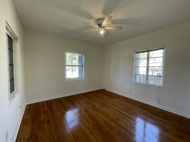 spare room featuring dark hardwood / wood-style flooring and ceiling fan