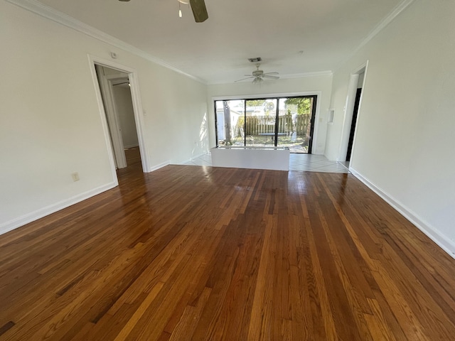 spare room with ornamental molding, dark wood-type flooring, and ceiling fan