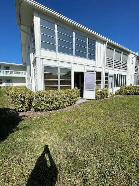 rear view of property with a lawn