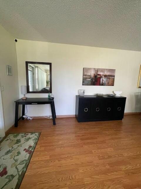 miscellaneous room featuring hardwood / wood-style floors and a textured ceiling