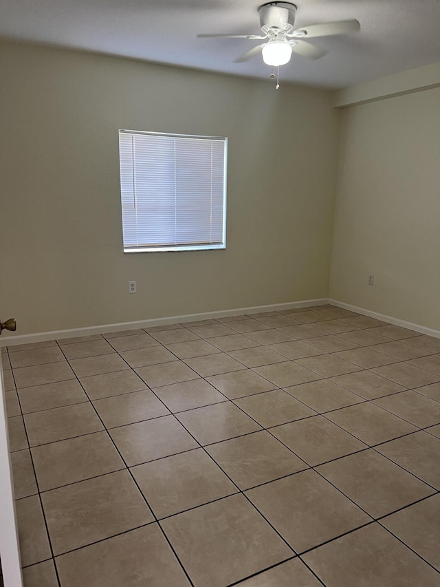 empty room featuring ceiling fan and light tile patterned floors