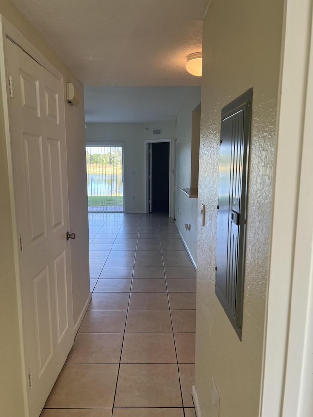 hall featuring light tile patterned floors