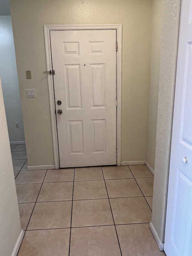 entryway featuring light tile patterned floors