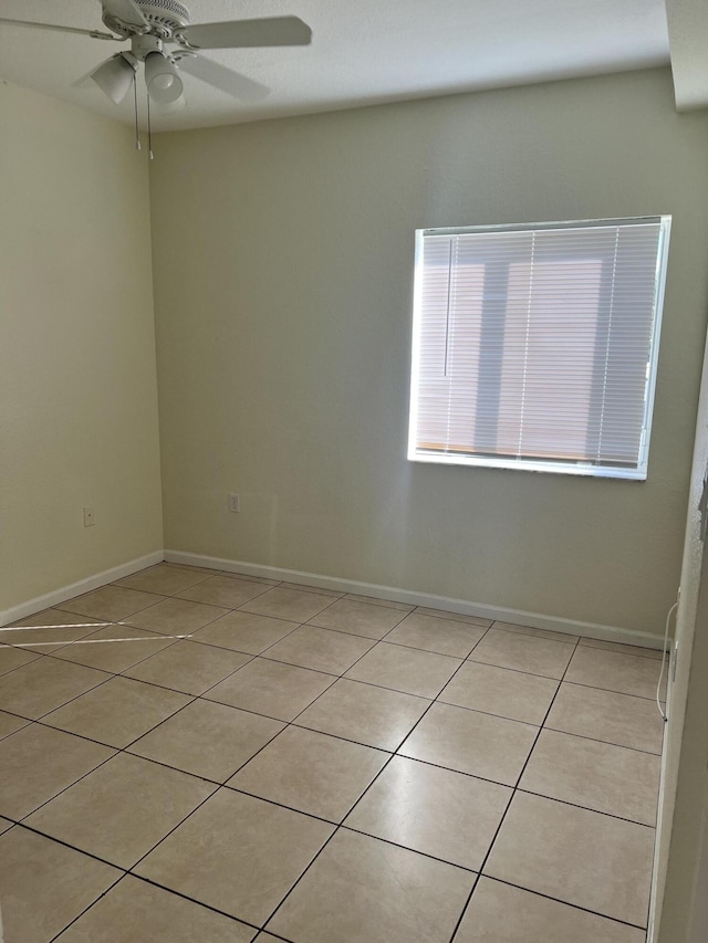 tiled empty room with ceiling fan