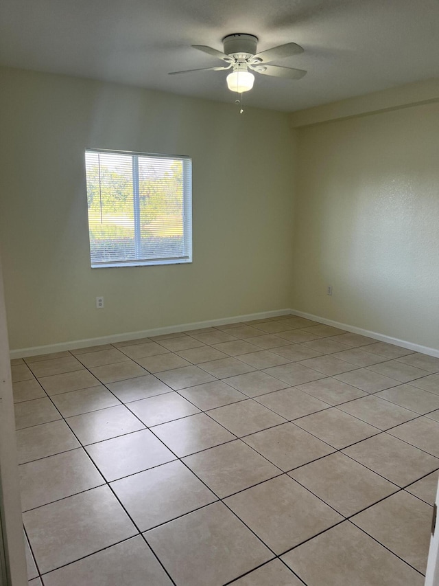 tiled empty room with ceiling fan